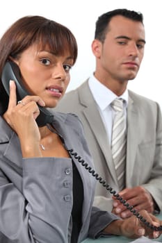 Business couple making important call