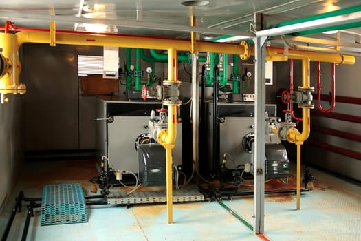 Putting mini-boiler, in the foreground and back-up boilers operating at a working dual-fuel, gas and diesel fuel.
