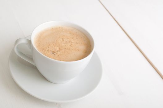 Creamy Espresso Coffee in White Cup on Table