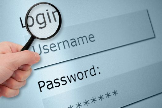 Man's Hand Holding Magnifying Glass over Browser Window With Username and Password Fields