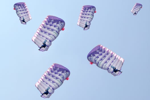 Many parachutes over a blue sky background