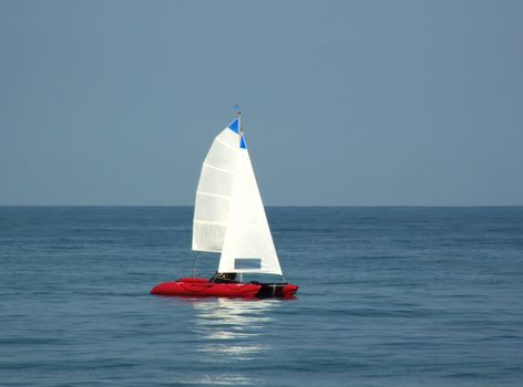 red boat over blue sky on sea