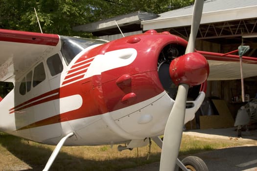 1941 private airplane sitting in front of hanger