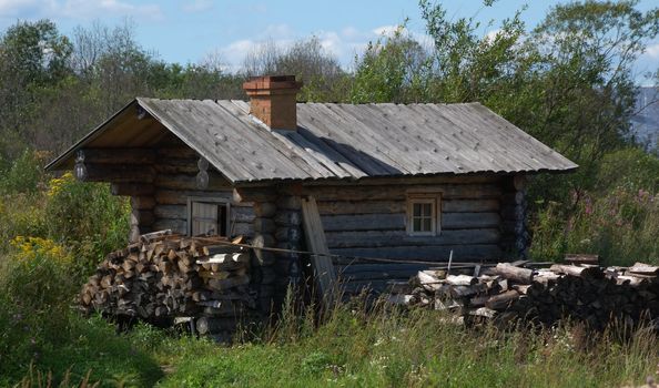 Solitary small wooden hermit hut in summer