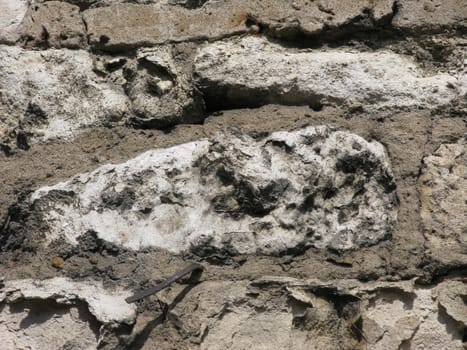 Piece of stone wall surface with metal pin