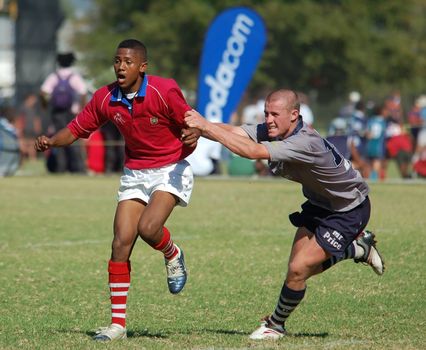 Two boys in a in a school rugby football match (Editorial)