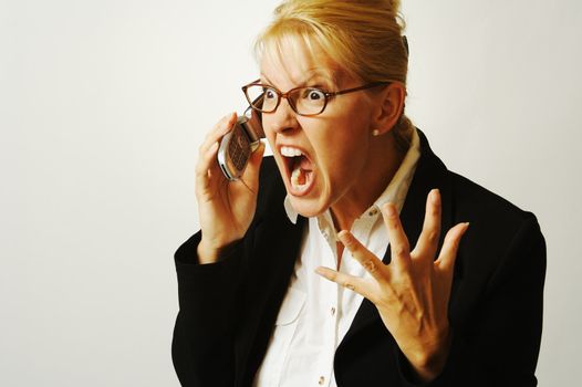 Business woman expresses her anger while on her cell phone.