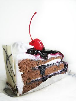 a isolated of black forest cake with cherry on top and white chocolate