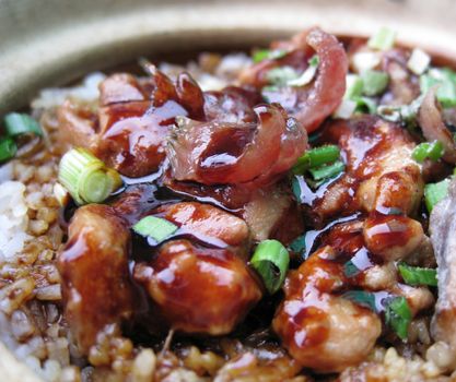 a bowl of clay pot chicken rice, asian style food