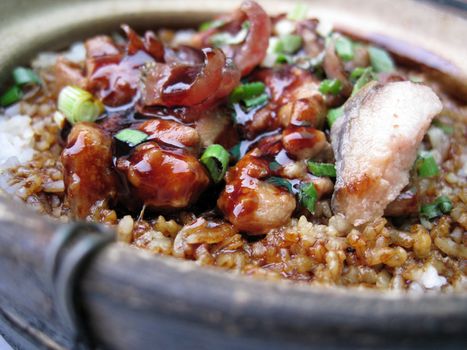 a bowl of clay pot chicken rice, asian style food