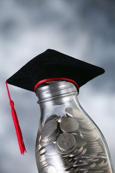 Bottle of cash with graduation cap.