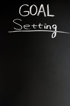 Goal setting written with chalk on a blackboard