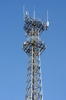 Mobile phone base station and antenna tower against the blue sky