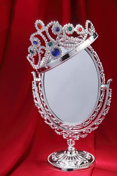 Tiara on top of a mirror.