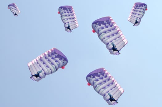 Many parachutes over a blue sky background