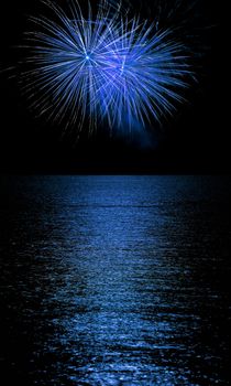 Long Exposure of Fireworks Reflecting on Calm Rippling Water
