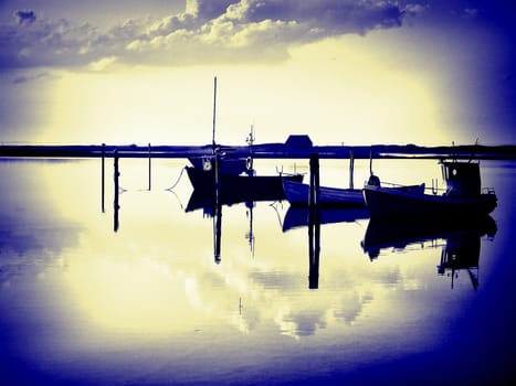 Reflection of a small dinghy dory boats in the sunset great sailing boating fishing image digital art manipulation