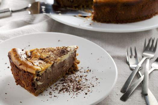 Slice of chocolate cheese cake on table with forks.
