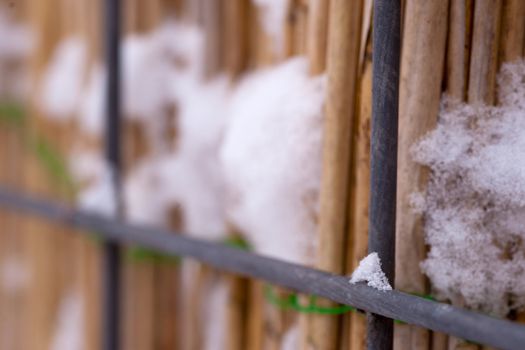 It's wintertime, a fence with a little bit of snow