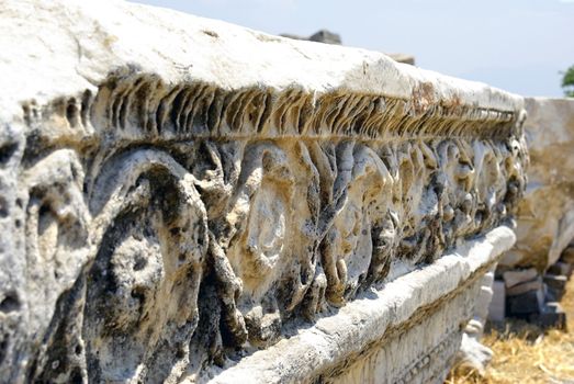 Ancient marble ruins with ornamental decoration.