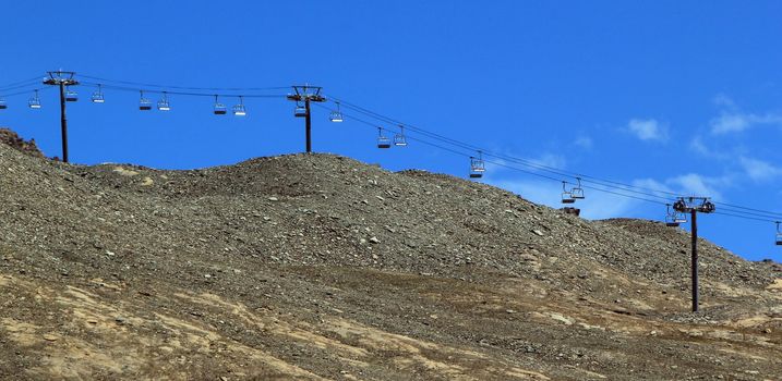 Chair lift at ski resort during beautiful summer day