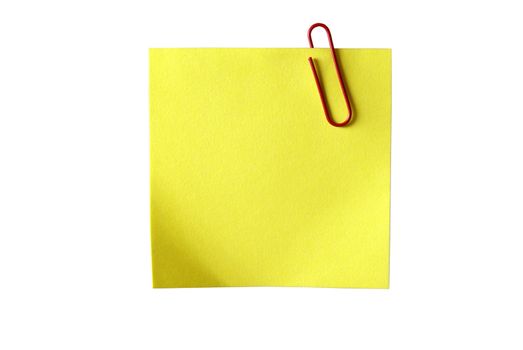 Yellow sticky paper with red clip. Isolated on white background with clipping path.