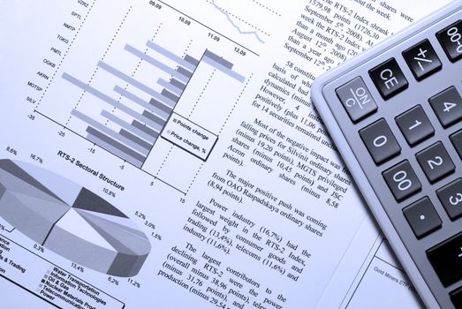 Calculator and stock market report with visual aids.