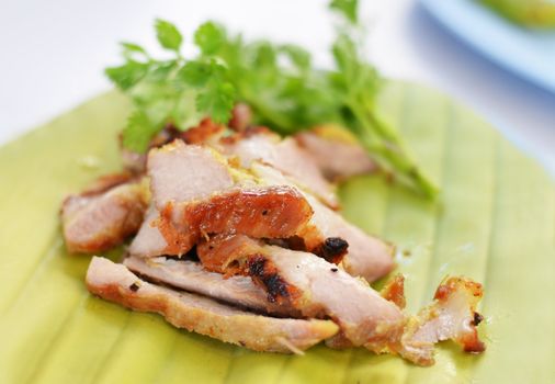 a delicious sliced grilled pork served  with vegetables