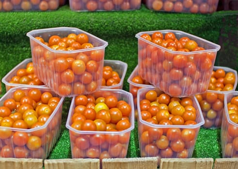 display of cocktail tomatoes presented in plastic containers