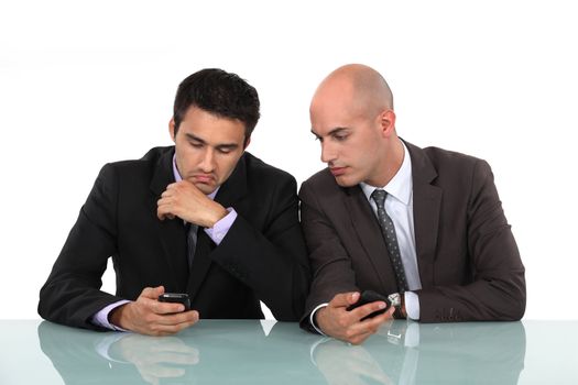 Businessmen comparing phones