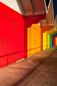 Different beach huts on the empty beach in Great Britain