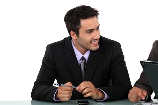 Smart businessman sitting at a desk