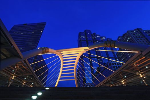 Bangkok pubic skywalk in business district downtown cityscape at night