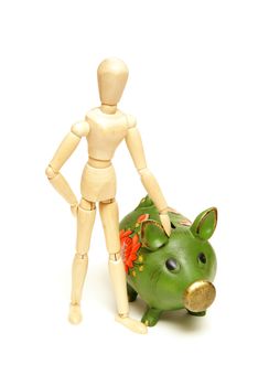 A mannequin stays close to his pig bank for financial concepts.