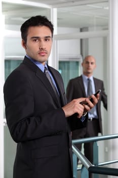 businessman at the office holding a cell phone