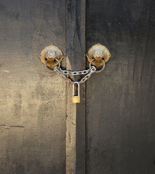 Old wooden door with Chain key lock
