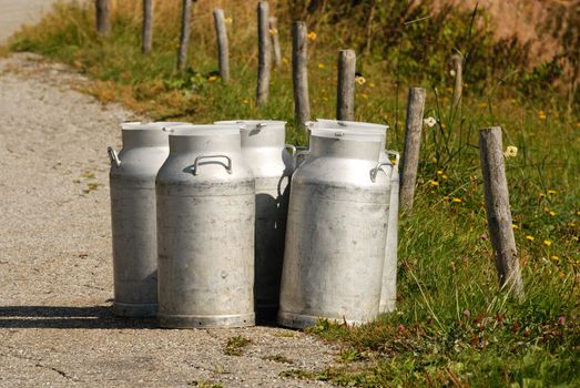 Milk cans ready for collection the evening, facing Mont Blanc, Savoie