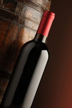 red wine bottle and wodden barrel