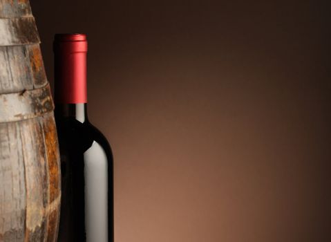 red wine bottle and wodden barrel