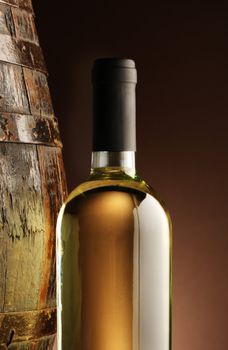 white wine bottle and woodden barrel