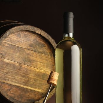 white wine bottle, woodden barrel, and corkscrew 