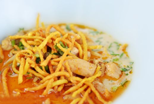 A noodle dish in a yellow curry with chicken. Khao soy a famous northern Thai food.