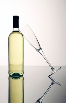 bottle and glass on a reflective surface