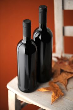  bottles of red wine on a white wooden chair (shallow dof)