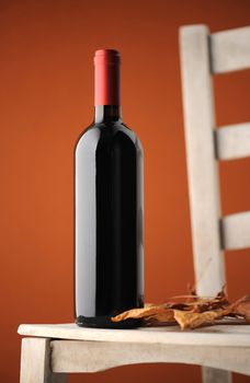 red wine bottle on a white wooden chair