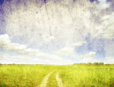 grunge image of green field and blue sky