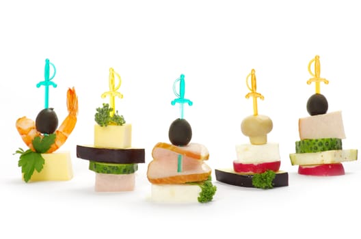 Close-up of canape with olives, cheese and over white