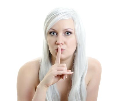 attractive blond girl with a finget at lips isolated on white background