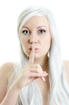 closeup portrait of attractive blond girl with a finget at lips isolated on white background