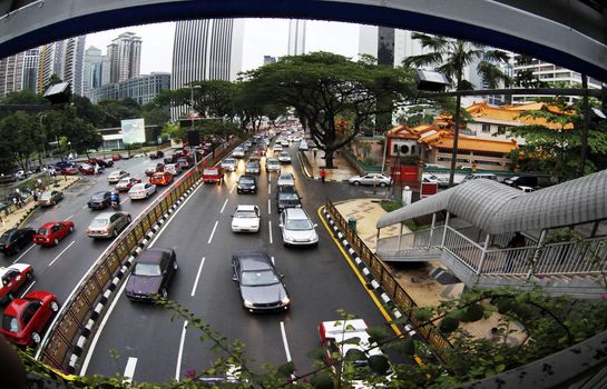 famous landmark of kuala lumpur with fast moving vehicle on highway